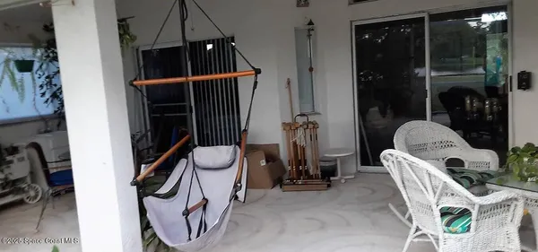 a view of backyard of the house with outdoor seating
