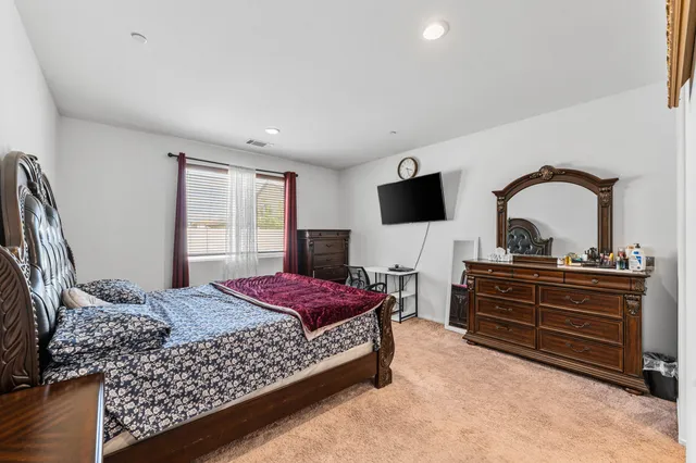 a bedroom with a bed and a flat screen television