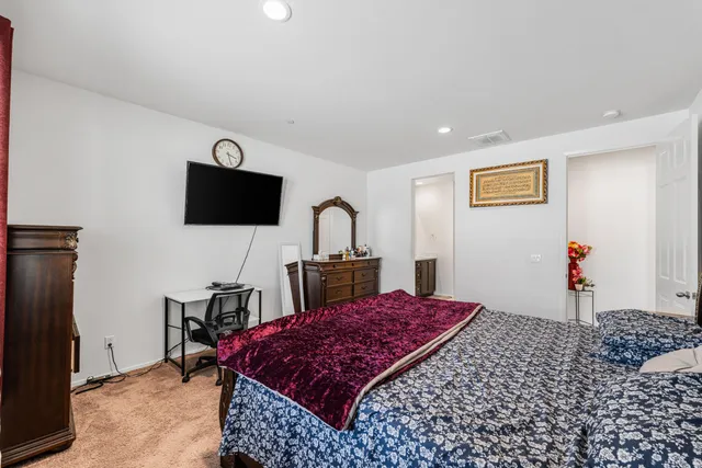 a bed room with a bed and a television