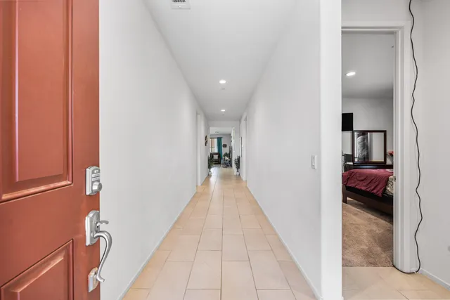 a view of a hallway with a livingroom and a way to dinning room with furniture