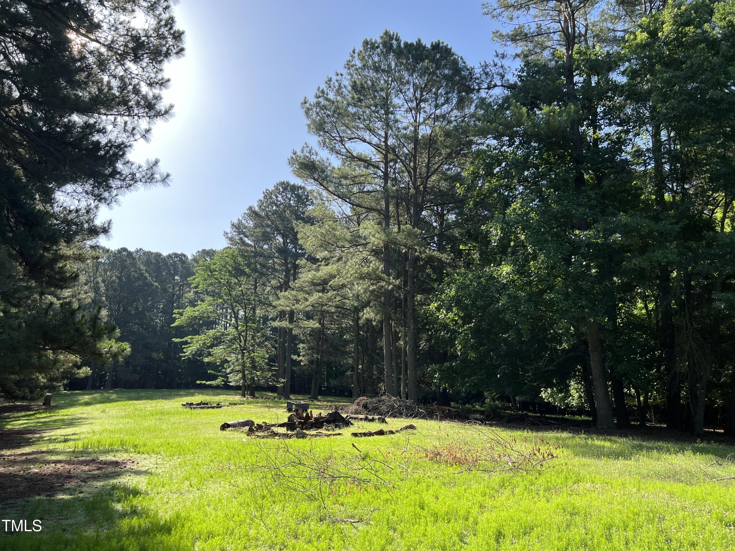 12932 Ghoston Road Wake Forest, NC 27587 - Photo 17 of 22 a view of a swimming pool with trees in the background