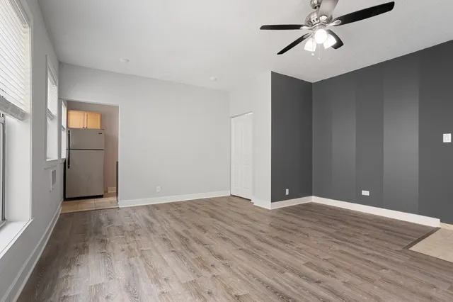 a view of an empty room with wooden floor
