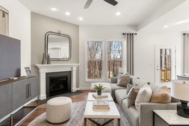 a living room with furniture a window and a fireplace