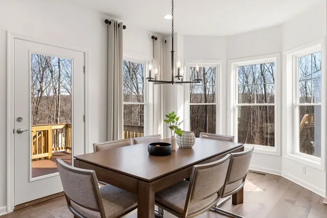 a view of a dining room with a table and chairs