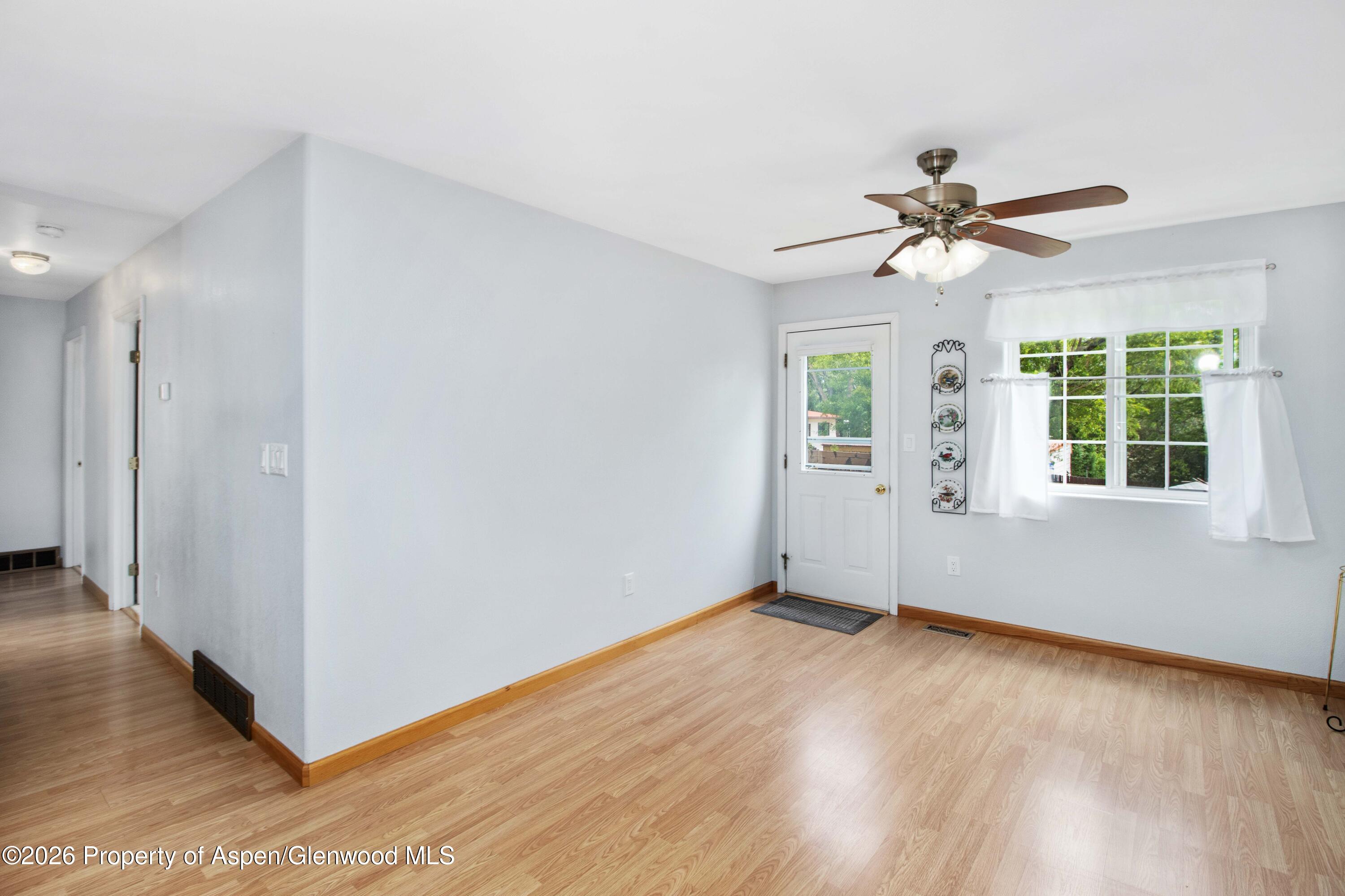 660 Aspen Avenue Rifle, CO 81650 - Photo 10 of 30 a view of a big room with wooden floor and windows