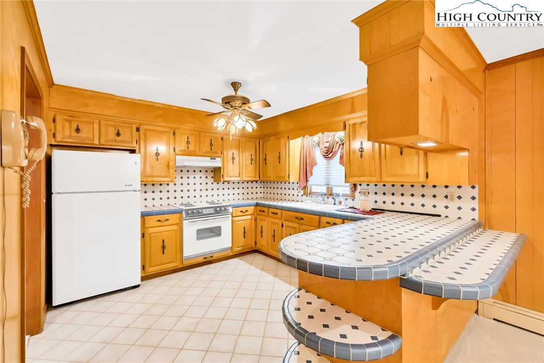 354 Old Wilkes Road Jefferson, NC 28640 - Photo 15 of 50 a kitchen with stainless steel appliances a sink and a refrigerator