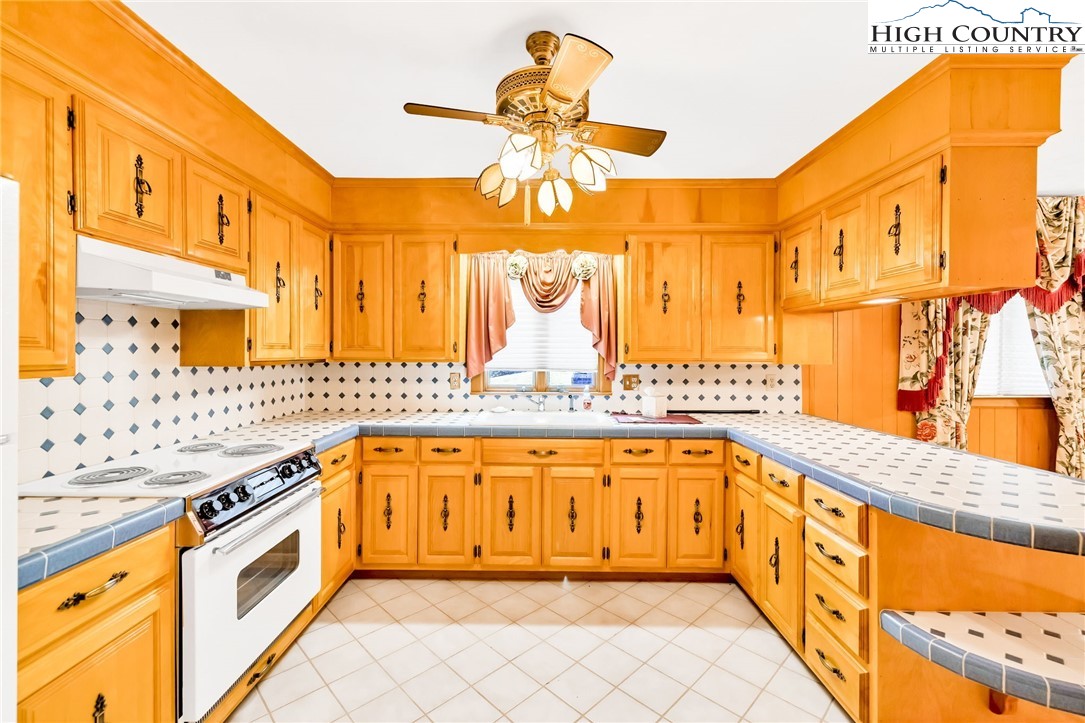 354 Old Wilkes Road Jefferson, NC 28640 - Photo 16 of 50 a large kitchen with stainless steel appliances granite countertop a sink and cabinets