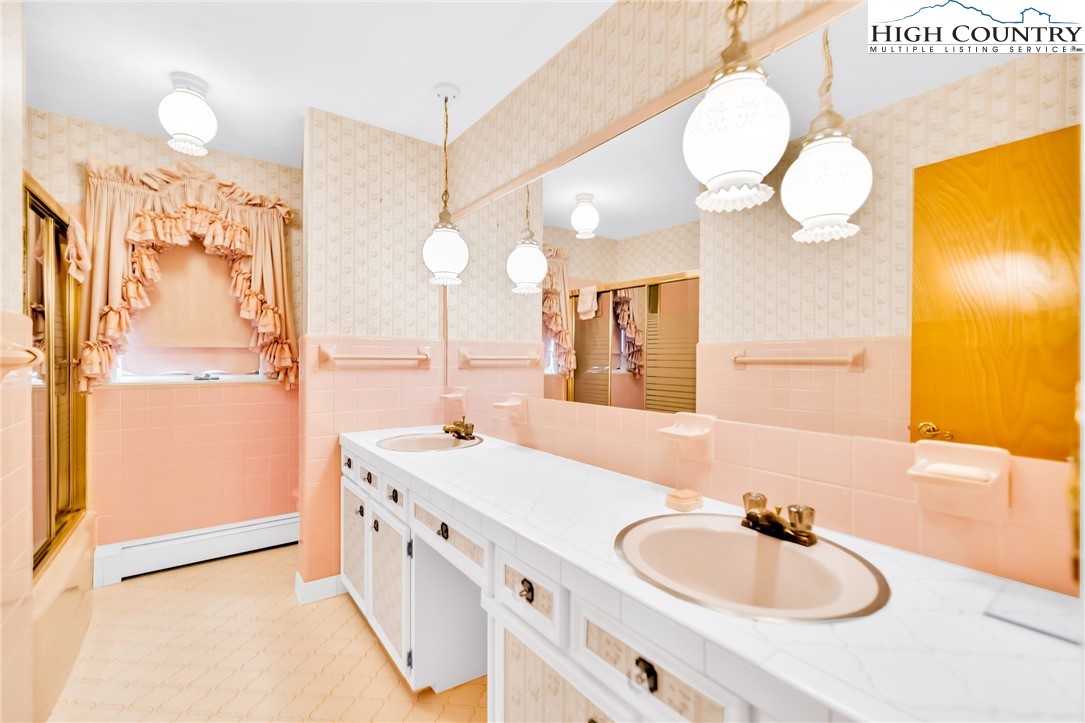 354 Old Wilkes Road Jefferson, NC 28640 - Photo 21 of 50 a bathroom with a double vanity sink mirror and