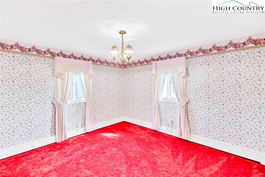 354 Old Wilkes Road Jefferson, NC 28640 - Photo 22 of 50 a bedroom with a bed and a dresser