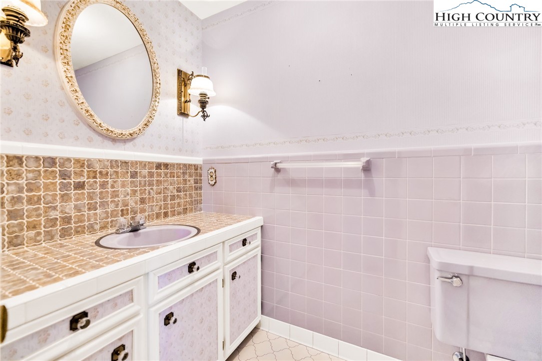 354 Old Wilkes Road Jefferson, NC 28640 - Photo 24 of 50 a bathroom with a sink and a mirror