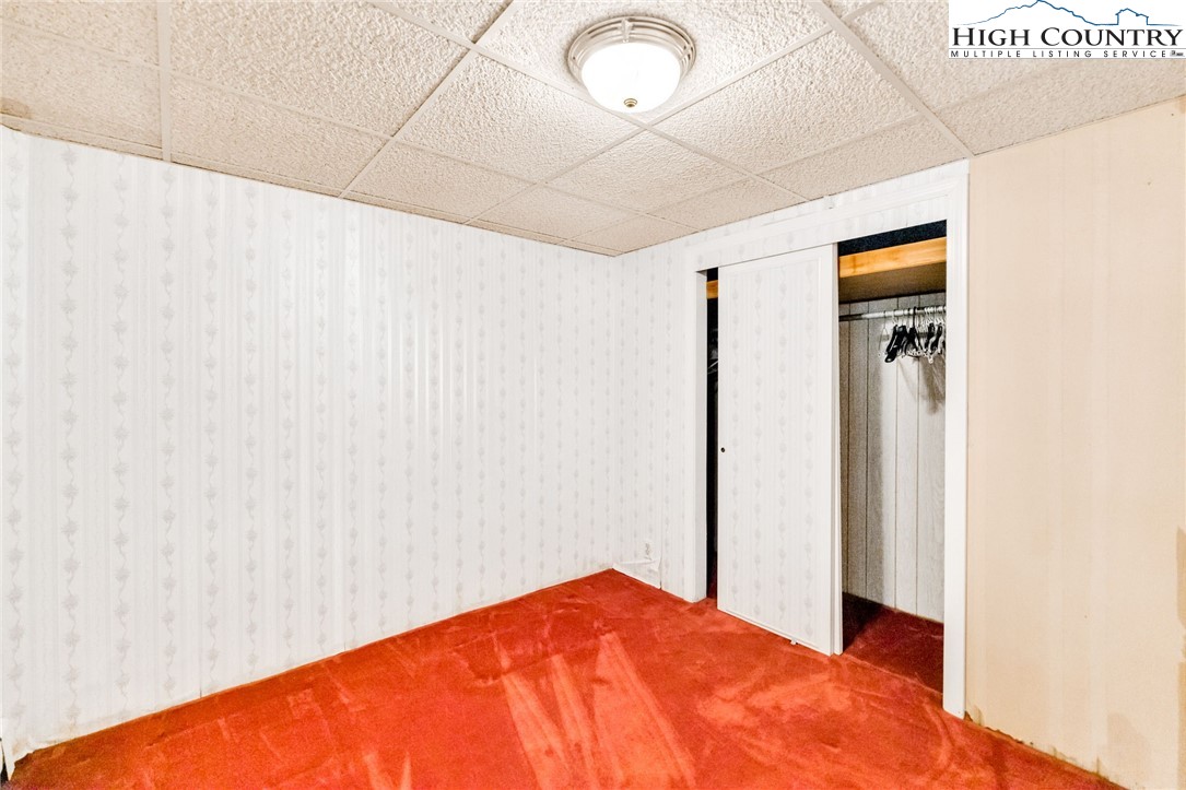 354 Old Wilkes Road Jefferson, NC 28640 - Photo 41 of 50 a bedroom with a bed and a plant