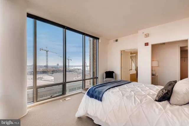 a bedroom with a large bed and a large window