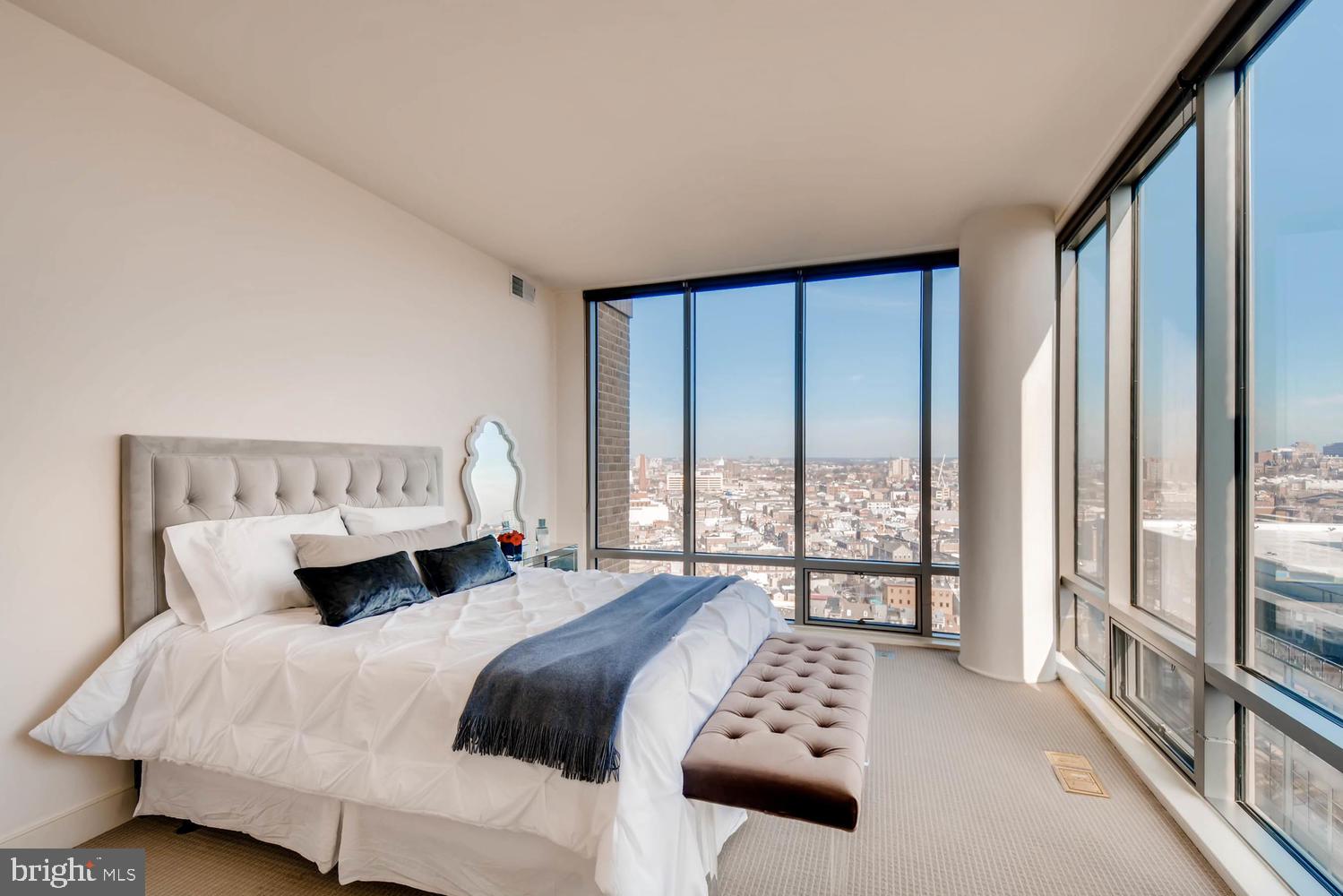 675 President Street, Unit 1806 Baltimore, MD 21202 - Photo 15 of 46 a bedroom with a bed and a large window