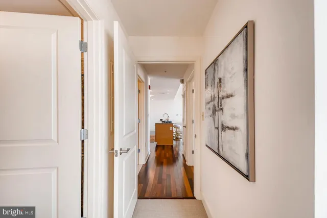 a view of a hallway with wooden floor and staircase