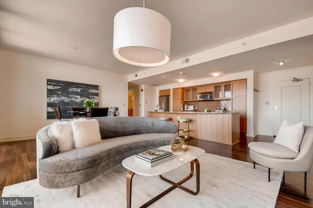a living room with furniture and a wooden floor