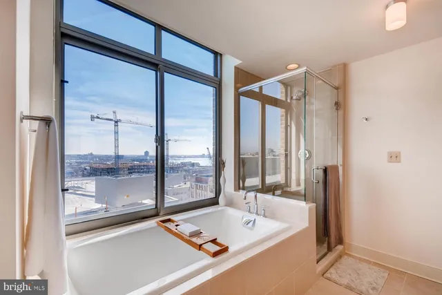 a bathroom with a tub and a large window