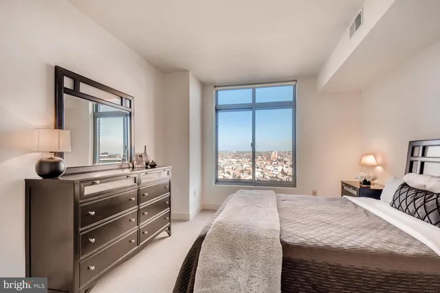 a bedroom with a bed and a dresser