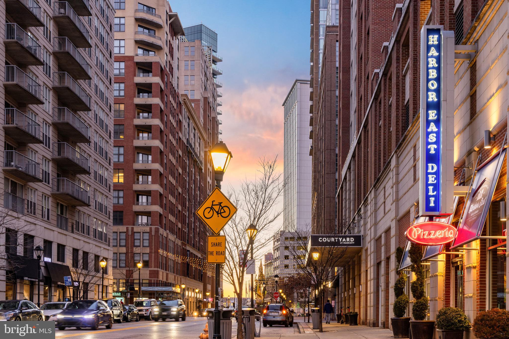 675 President Street, Unit 1806 Baltimore, MD 21202 - Photo 39 of 46 a city street lined with tall buildings and cars parked on the street