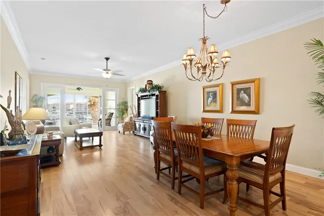 a view of a dining room with furniture wooden floor and chandelier