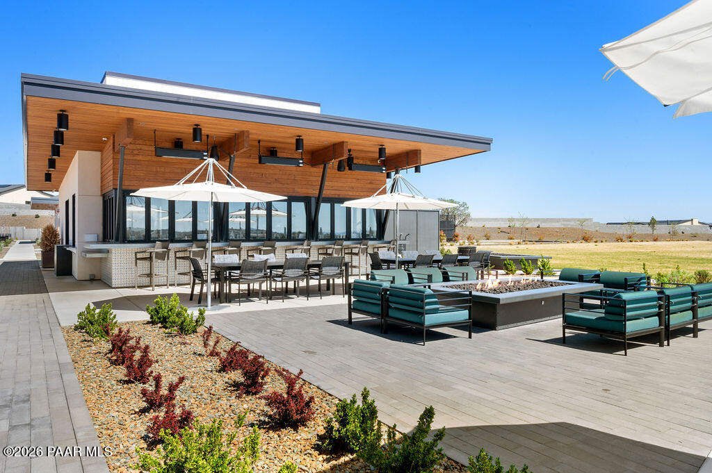 5994 East Killen Loop Prescott Valley, AZ 86314 - Photo 75 of 119 a view of a patio with couches table and chairs under an umbrella