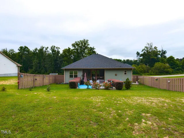 a view of a house with yard and sitting area