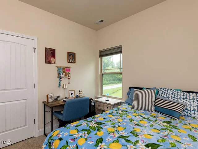 a bedroom with a bed and a table in it