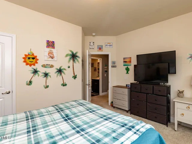 a bedroom with a bed and a flat screen tv