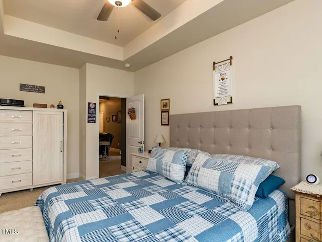 a bedroom with a large bed and cabinets