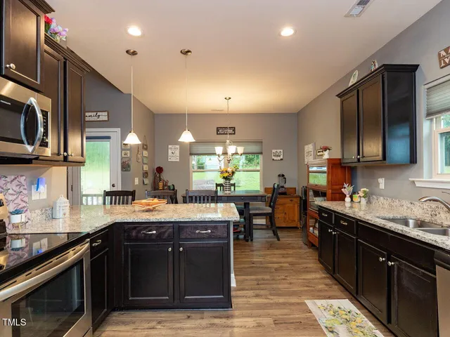 a open kitchen with stainless steel appliances granite countertop a sink stove and cabinets