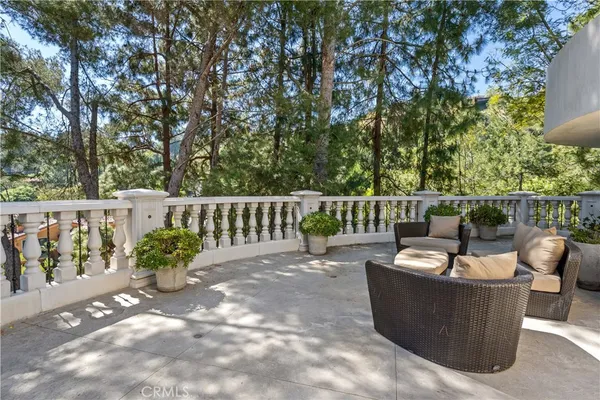 a roof deck with couches and wooden fence