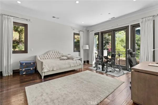 a bedroom with furniture and a large window