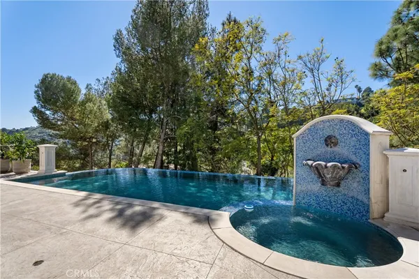 a view of a swimming pool in a backyard