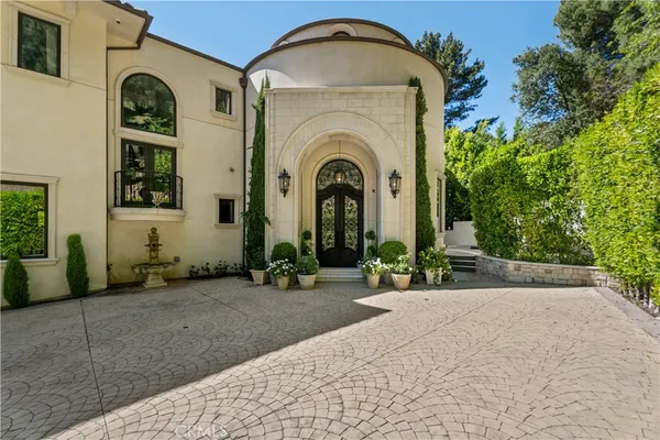 a view of a brick house with potted plants