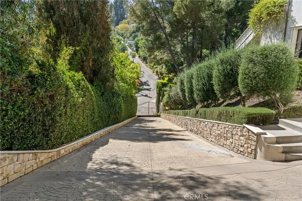a view of a pathway with a wrought fence