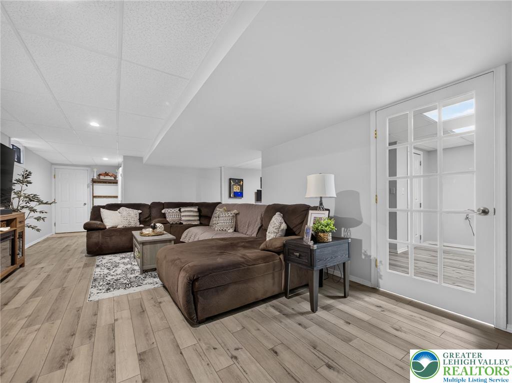 4148 Ross Road Bethlehem, PA 18020 - Photo 63 of 67 A well-lit, open-concept living space with resilient wood-look flooring and a functional drop ceiling.