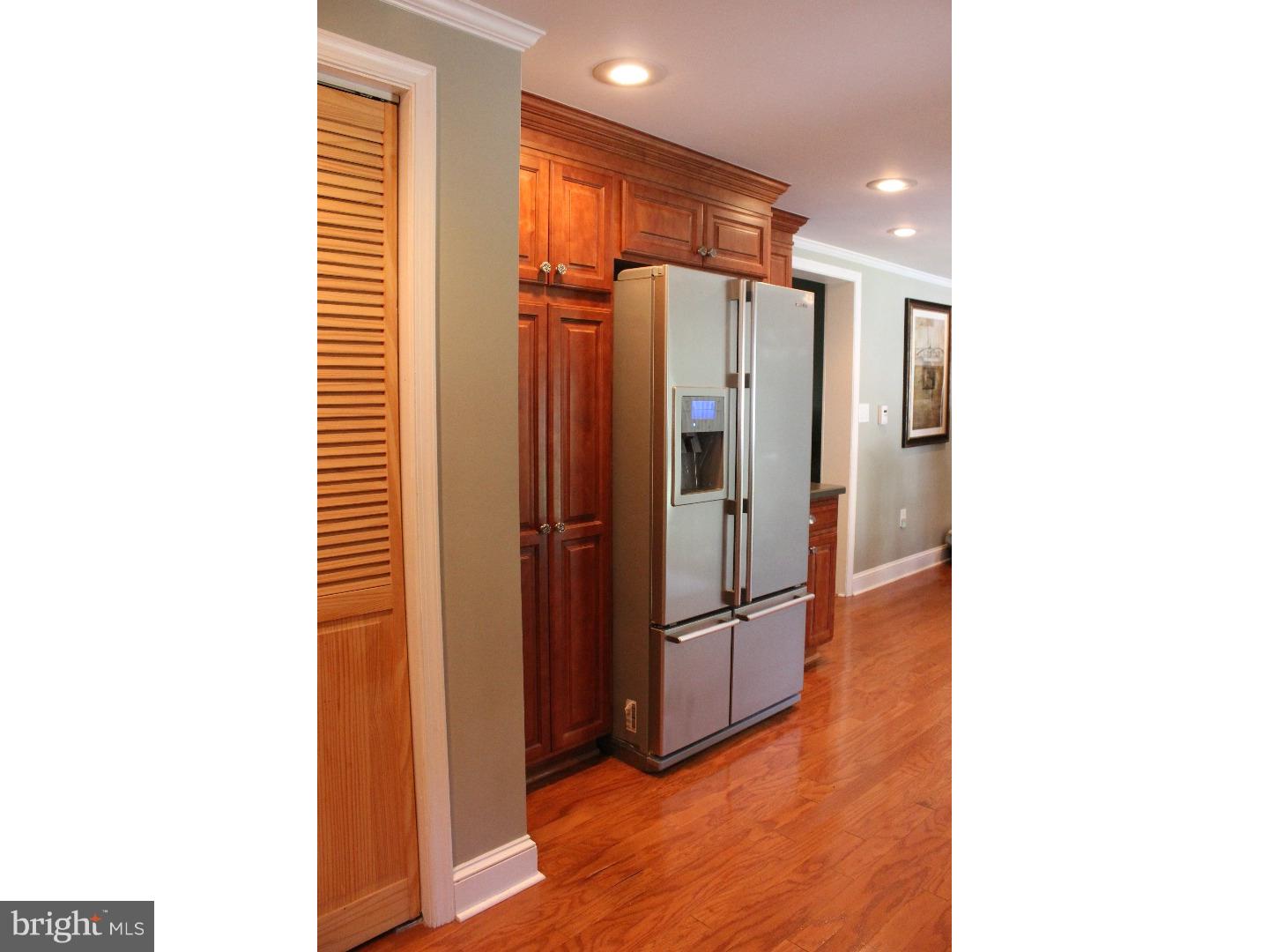 109 Prospect Road Sicklerville, NJ 08081 - Photo 11 of 20 a view of a refrigerator in kitchen and an empty room