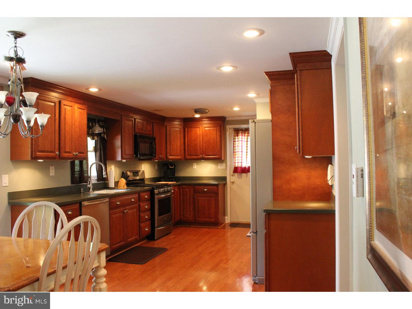 109 Prospect Road Sicklerville, NJ 08081 - Photo 12 of 20 a kitchen with stainless steel appliances granite countertop a refrigerator a sink dishwasher a stove and a dining table with wooden cabinet