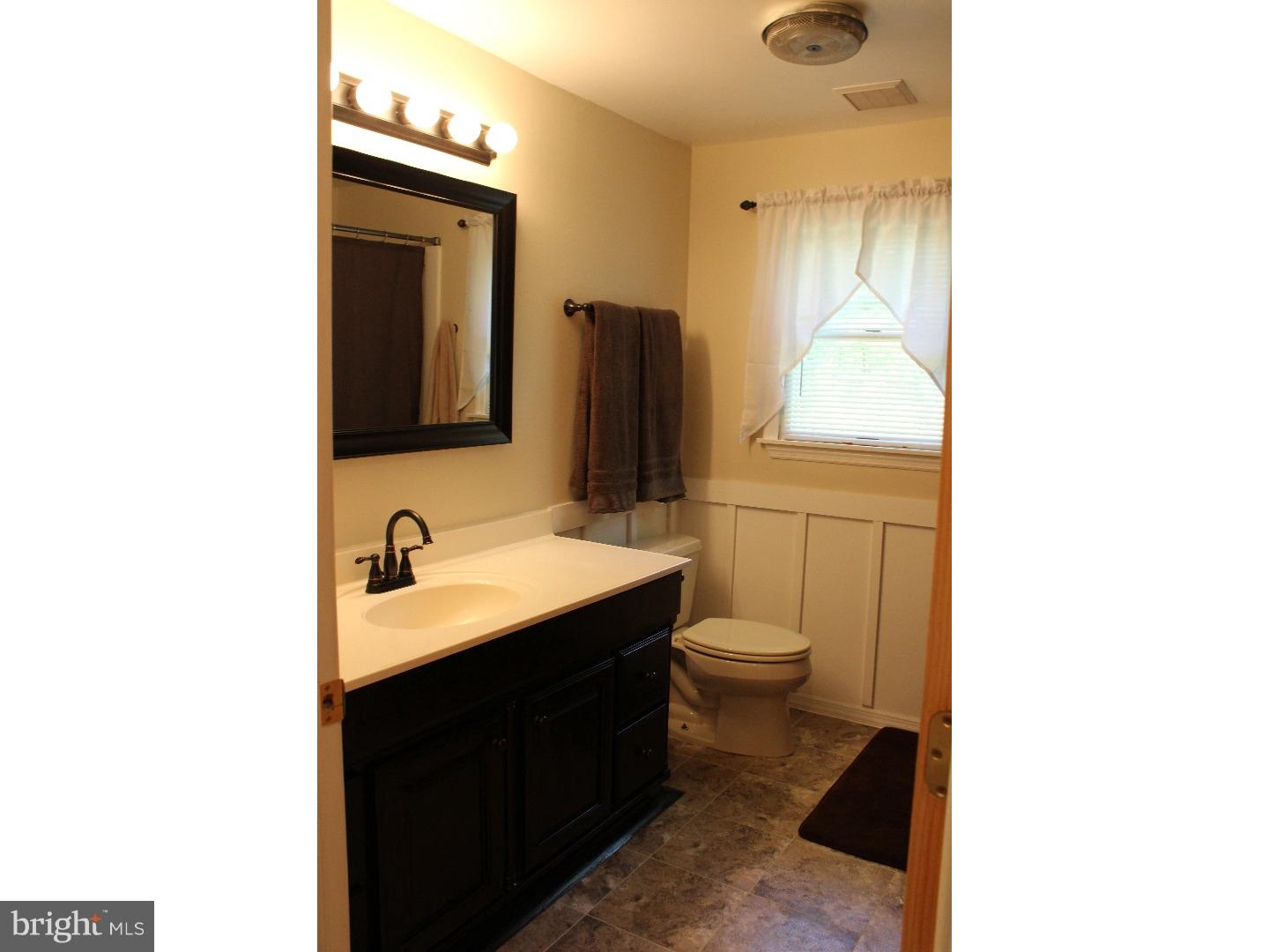 109 Prospect Road Sicklerville, NJ 08081 - Photo 14 of 20 a bathroom with a toilet sink and mirror