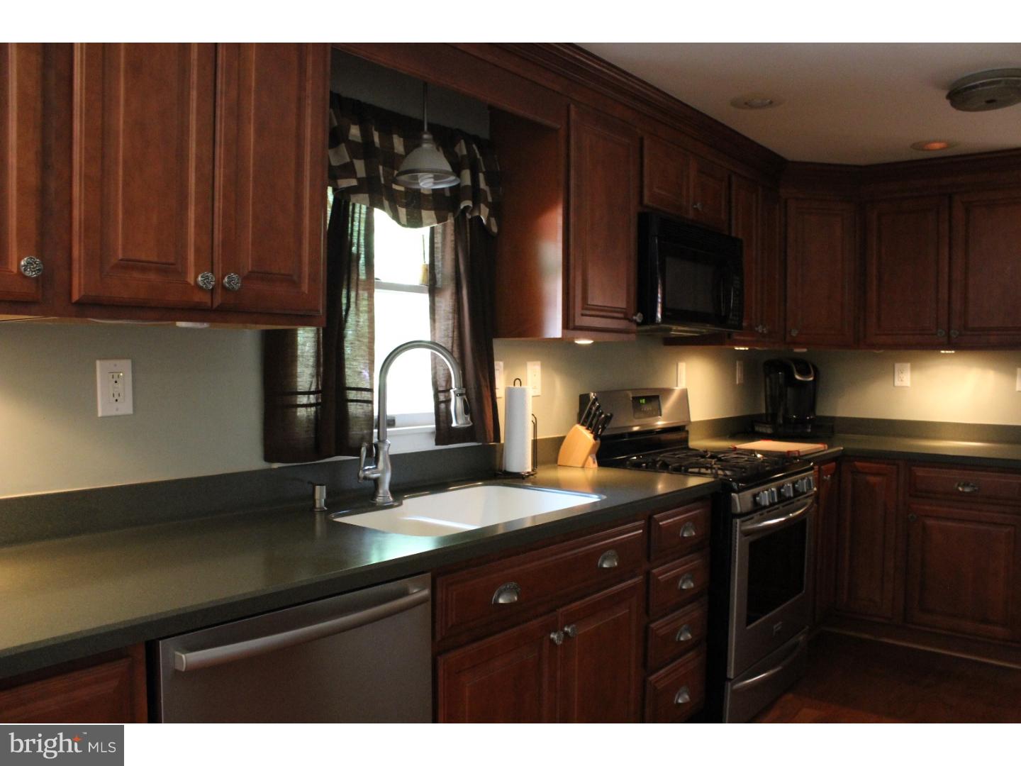 109 Prospect Road Sicklerville, NJ 08081 - Photo 10 of 20 a kitchen with granite countertop a sink cabinets and stainless steel appliances