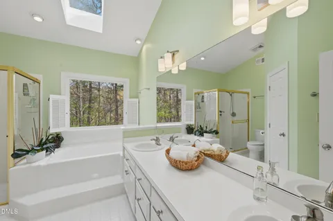 a bathroom with a sink a tub and a mirror