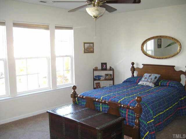 7710 Elon Drive Raleigh, NC 27613 - Photo 9 of 12 Upstairs bedroom with walk-in closet & ceiling fan Other
