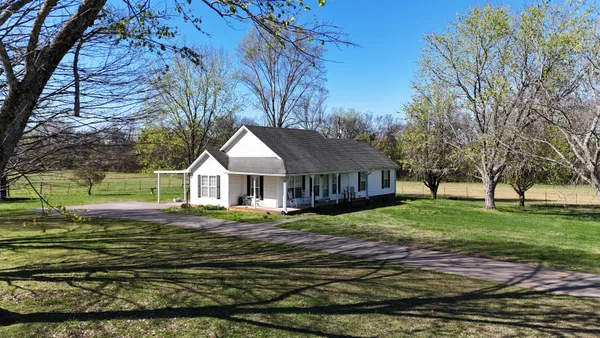 a view of a garden with an outdoor seating
