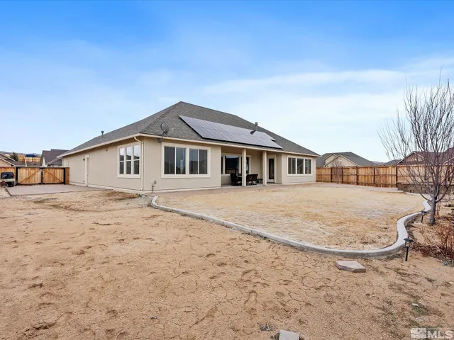 a front view of a house with a dirt yard