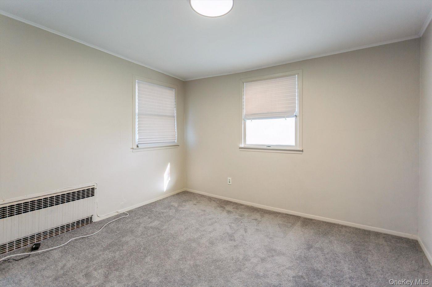 1 Sutton Place Lawrence, NY 11559 - Photo 20 of 38 an empty room with windows