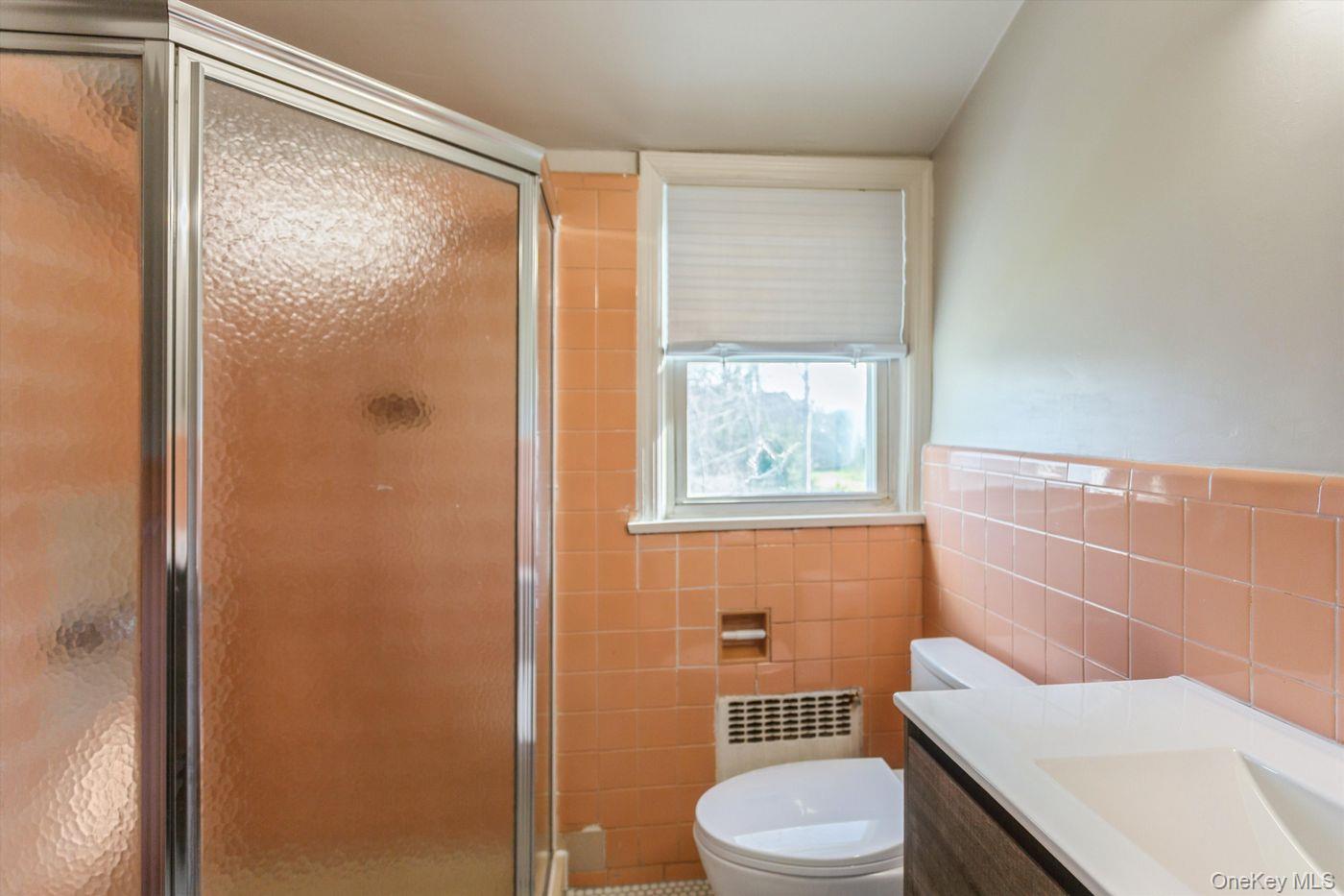 1 Sutton Place Lawrence, NY 11559 - Photo 26 of 38 a bathroom with a toilet a sink and a shower