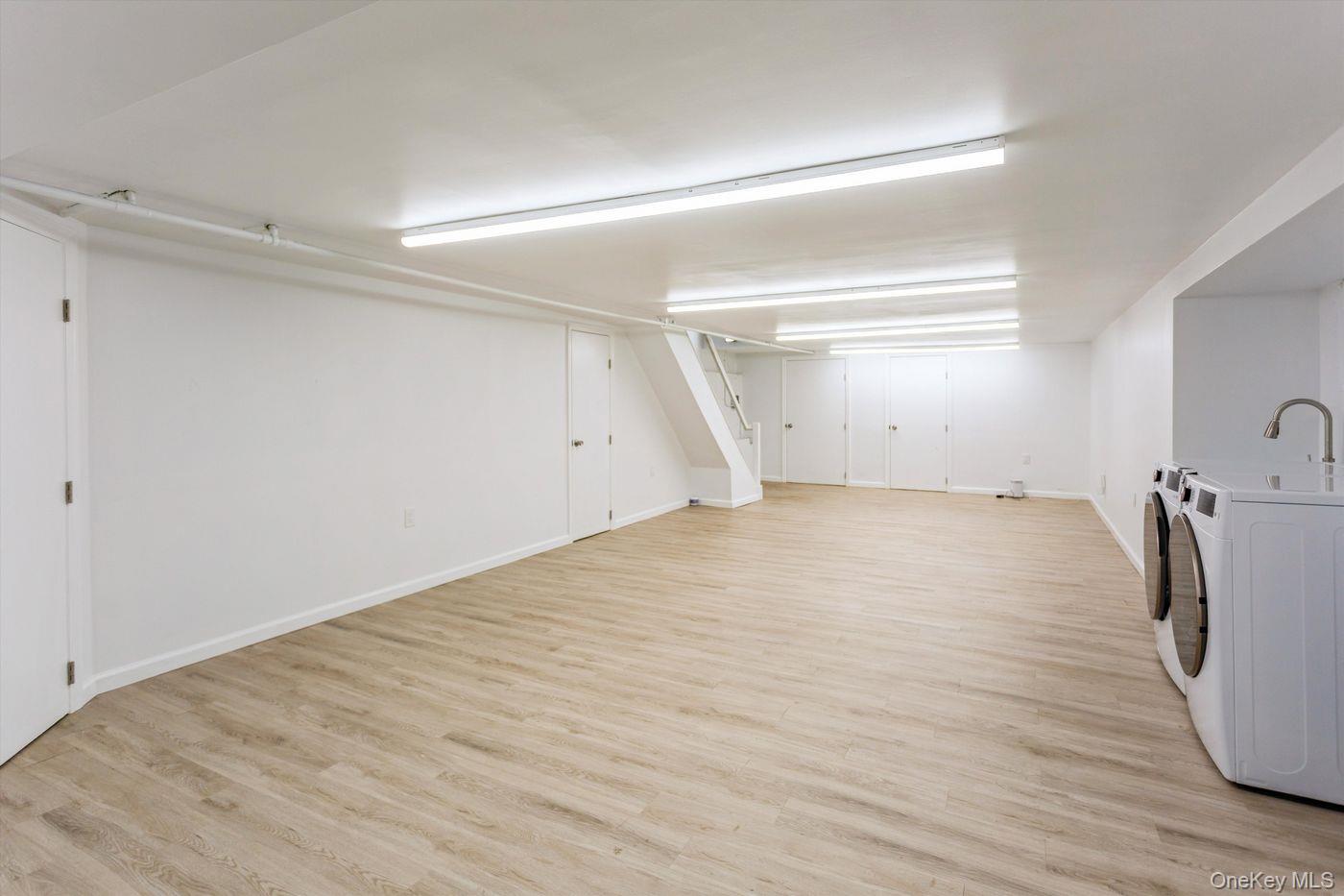 1 Sutton Place Lawrence, NY 11559 - Photo 32 of 38 a view of empty room with wooden floor