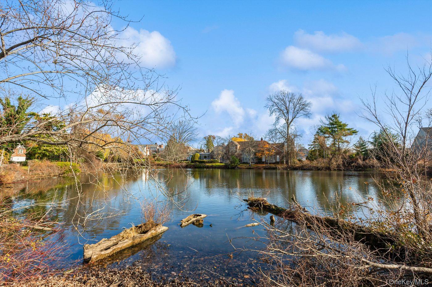 1 Sutton Place Lawrence, NY 11559 - Photo 33 of 38 a view of a lake with houses in the back