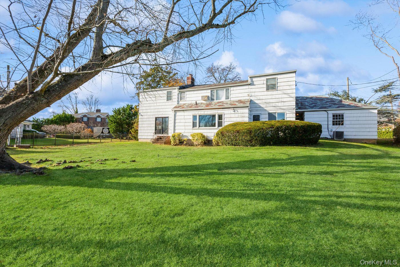1 Sutton Place Lawrence, NY 11559 - Photo 34 of 38 Rear view of property with a chimney