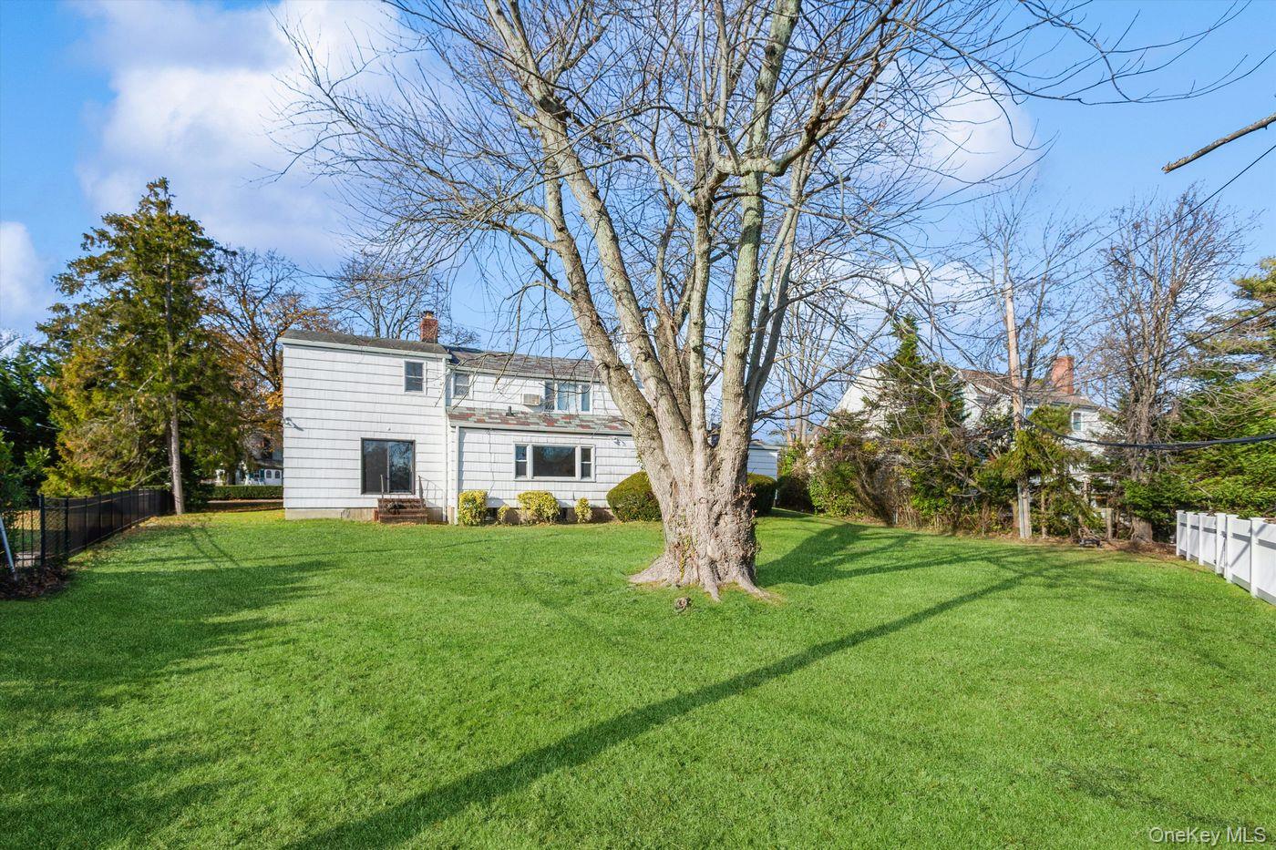 1 Sutton Place Lawrence, NY 11559 - Photo 35 of 38 a view of a house with a yard