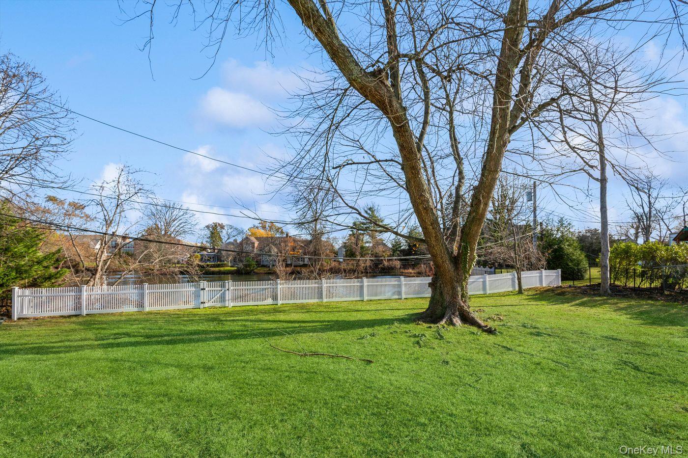1 Sutton Place Lawrence, NY 11559 - Photo 37 of 38 a view of a big yard with a big trees